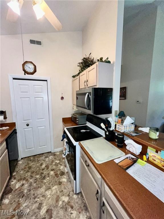 47 Woodland Chase Blvd, Niles, OH 44446 - kitchen with visible vents, electric range oven, ceiling fan, stone finish floor, and stainless steel microwave