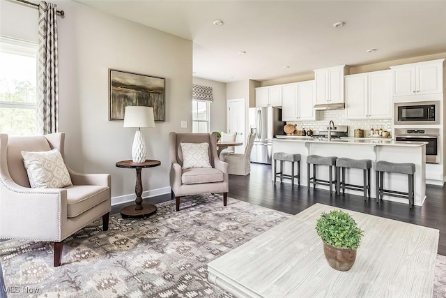 living room featuring baseboards and dark wood finished floors