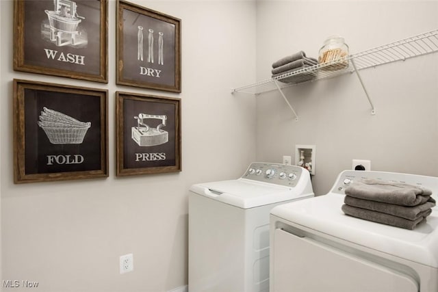 laundry room with cabinet space and washer and clothes dryer