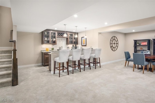 bar featuring baseboards, wet bar, stairway, recessed lighting, and light carpet