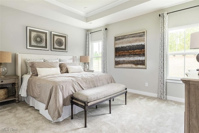 bedroom featuring light colored carpet and baseboards