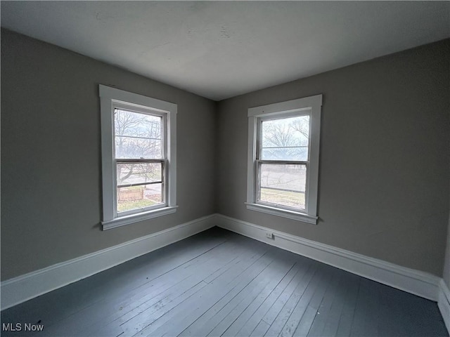 945 E 149th St, Cleveland, OH 44110 - empty room with dark wood-type flooring and baseboards