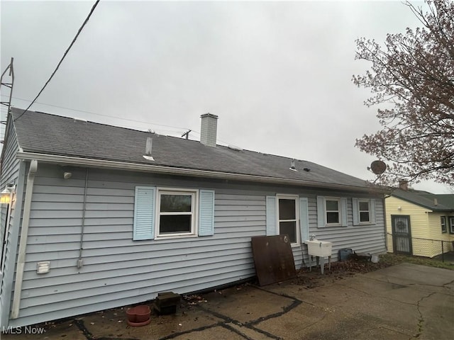 2424 Mccartney Rd, Youngstown, OH 44505 - rear view of property with a patio area, a sink, and a chimney