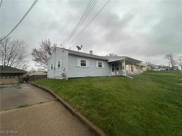 2424 Mccartney Rd, Youngstown, OH 44505 - rear view of house with covered porch, fence, and a lawn