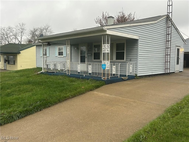 2424 Mccartney Rd, Youngstown, OH 44505 - view of front facade with a porch, a front lawn, and a chimney