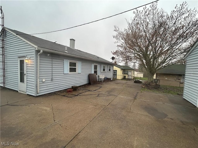 2424 Mccartney Rd, Youngstown, OH 44505 - rear view of property with a patio area and a chimney
