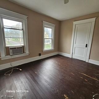 702 Dickson St, Youngstown, OH 44502 - unfurnished room with cooling unit, baseboards, and hardwood / wood-style floors