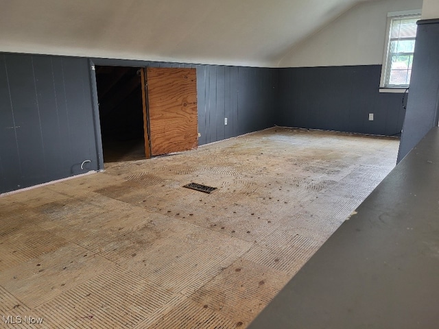 bonus room with visible vents and vaulted ceiling