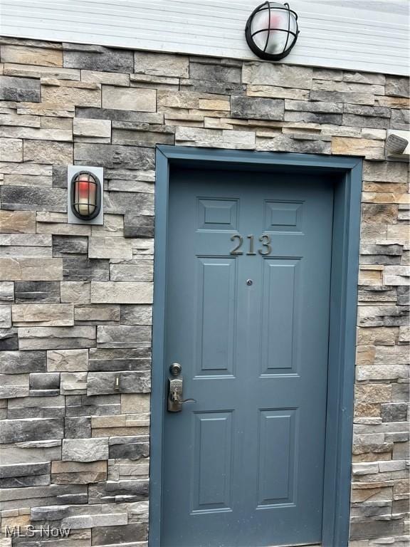 1252 Tri Motor Dr Unit 213, Put-In-Bay, OH 43456 - view of exterior entry featuring stone siding