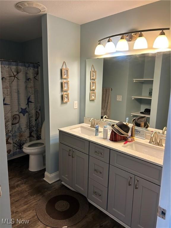 1252 Tri Motor Dr Unit 213, Put-In-Bay, OH 43456 - full bathroom featuring wood finished floors, double vanity, and a shower with curtain