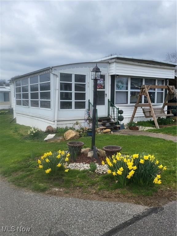 58 Wilpark Dr, Akron, OH 44312 - manufactured / mobile home with entry steps and a front lawn