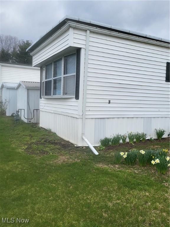 58 Wilpark Dr, Akron, OH 44312 - view of property exterior featuring an outbuilding and a lawn