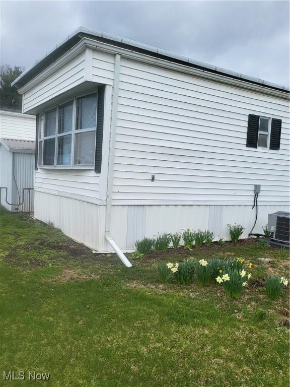 58 Wilpark Dr, Akron, OH 44312 - view of property exterior with a yard and central AC unit