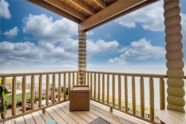wooden terrace featuring a water view