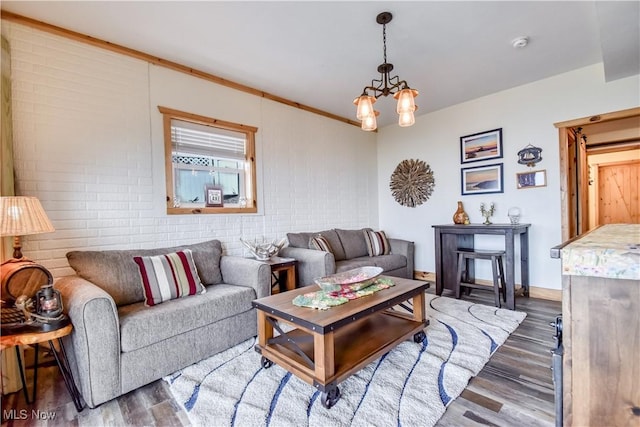 living room with a notable chandelier and wood finished floors