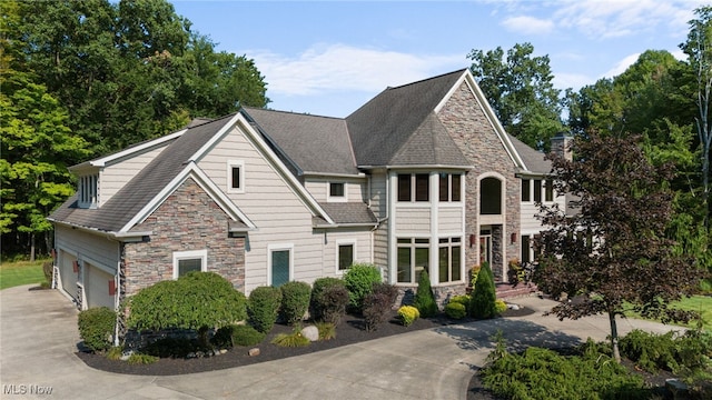11955 Epping Trl, Chardon, OH 44024 - view of front facade featuring stone siding, driveway, and a garage