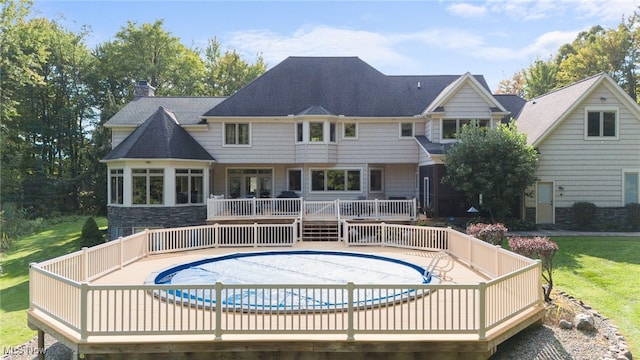 11955 Epping Trl, Chardon, OH 44024 - rear view of house with a wooden deck, a chimney, a covered pool, and roof with shingles