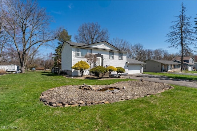 1863 Beaver Trl, Mineral Ridge, OH 44440 - bi-level home featuring a garage, a front yard, and driveway