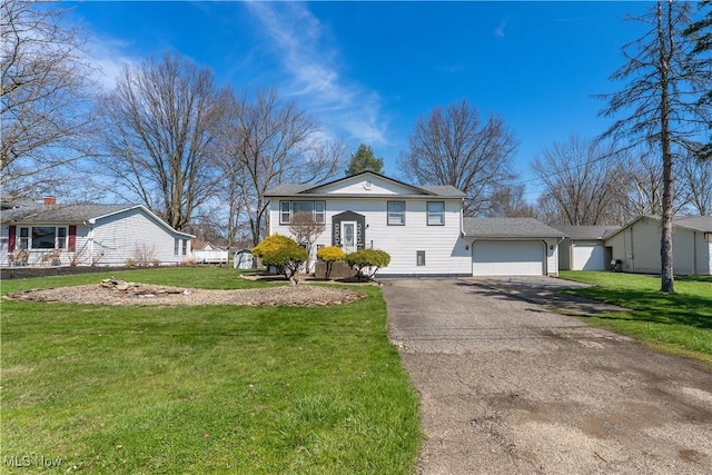 1863 Beaver Trl, Mineral Ridge, OH 44440 - bi-level home featuring a garage, a front yard, and driveway