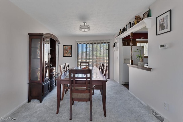 1863 Beaver Trl, Mineral Ridge, OH 44440 - dining room with visible vents, baseboards, light colored carpet, and a textured ceiling