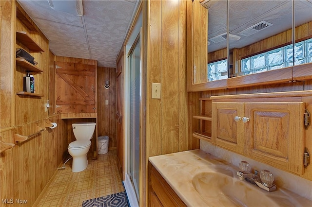 1863 Beaver Trl, Mineral Ridge, OH 44440 - full bathroom featuring vanity, a stall shower, toilet, wood walls, and visible vents