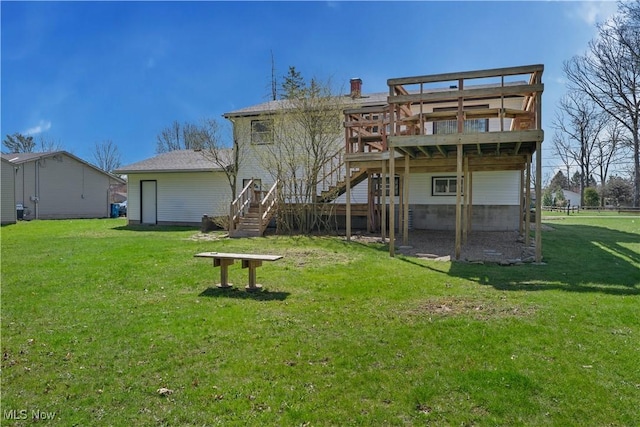 1863 Beaver Trl, Mineral Ridge, OH 44440 - rear view of property featuring stairs, a deck, a chimney, and a lawn