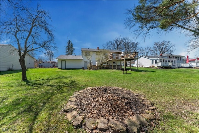 1863 Beaver Trl, Mineral Ridge, OH 44440 - back of house featuring a yard and a wooden deck