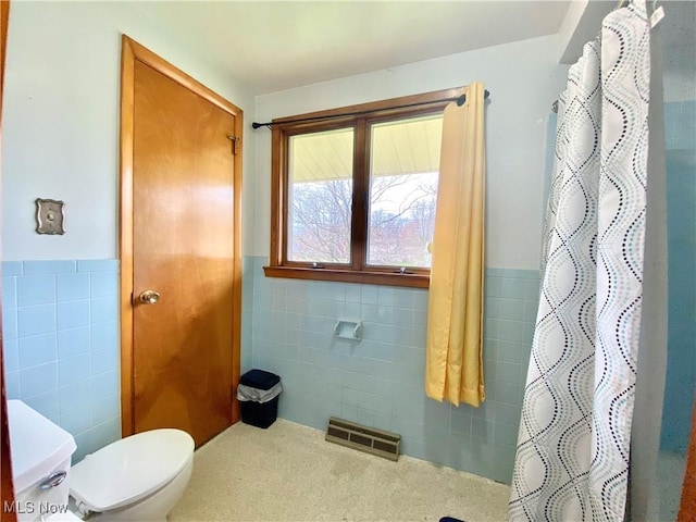 bathroom with wainscoting, tile walls, visible vents, and toilet