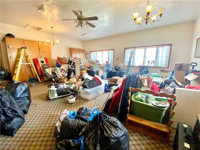 misc room featuring carpet floors and ceiling fan with notable chandelier