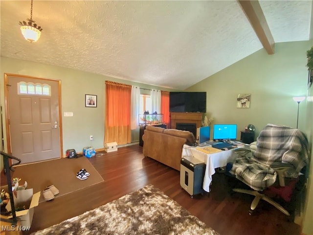 living area featuring a fireplace, dark wood-style flooring, a textured ceiling, and vaulted ceiling with beams