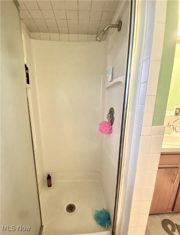 bathroom with a stall shower and vanity