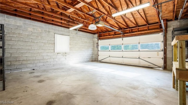 165 Reservoir Rd, New Concord, OH 43762 - garage featuring a garage door opener and concrete block wall