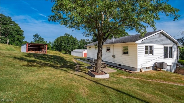 165 Reservoir Rd, New Concord, OH 43762 - exterior space featuring a shed, a yard, central AC, and an outdoor structure