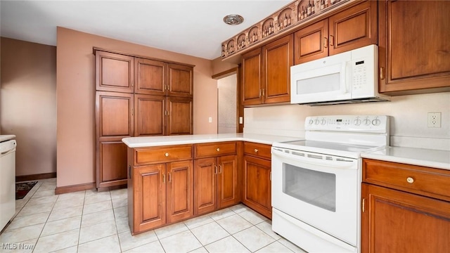 165 Reservoir Rd, New Concord, OH 43762 - kitchen featuring light tile patterned floors, light countertops, white appliances, a peninsula, and brown cabinetry