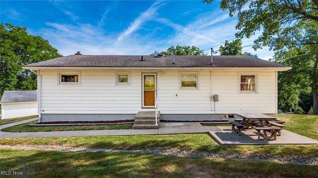 165 Reservoir Rd, New Concord, OH 43762 - rear view of property with a shingled roof, a yard, and a patio area