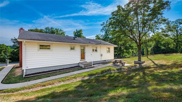165 Reservoir Rd, New Concord, OH 43762 - rear view of property with a patio area, entry steps, a chimney, and a lawn