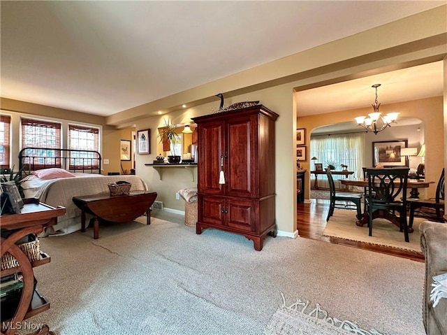 835 John St, Niles, OH 44446 - interior space with baseboards, multiple windows, a chandelier, and light carpet