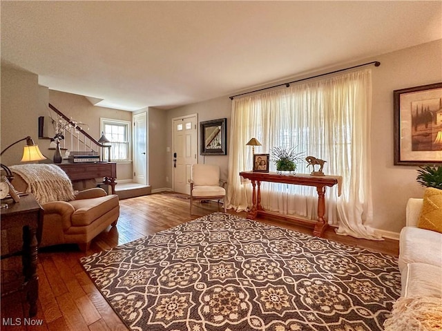 835 John St, Niles, OH 44446 - living room featuring baseboards, hardwood / wood-style flooring, and stairs