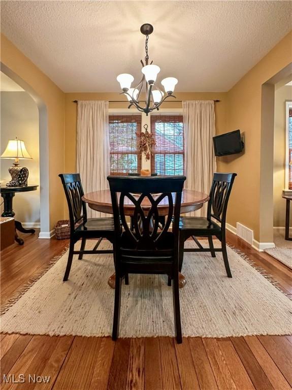 835 John St, Niles, OH 44446 - dining space with a notable chandelier, a textured ceiling, and wood finished floors