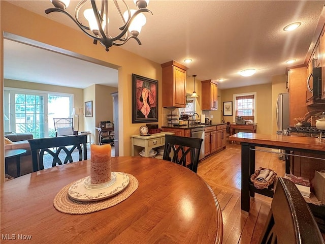 835 John St, Niles, OH 44446 - dining area with light wood-style flooring, recessed lighting, and a chandelier