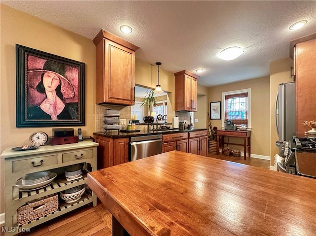 835 John St, Niles, OH 44446 - kitchen featuring wooden counters, a textured ceiling, a sink, and appliances with stainless steel finishes
