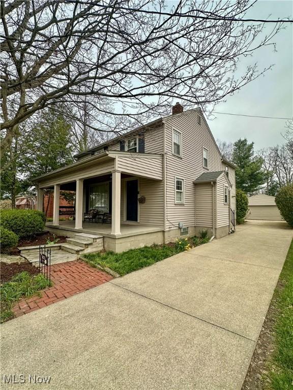 835 John St, Niles, OH 44446 - view of side of property with a chimney and covered porch