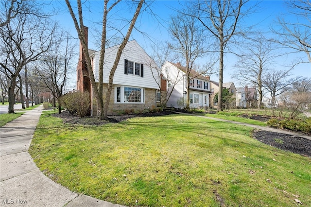 view of front of property with a chimney and a front yard