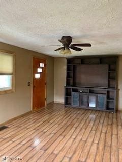 1317 Josephine St, Toronto, OH 43964 - unfurnished living room with a textured ceiling, ceiling fan, light wood-style floors, and baseboards