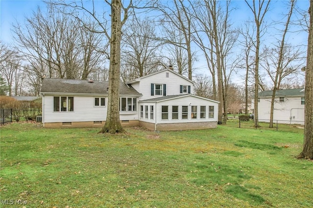 back of house featuring a shingled roof, crawl space, fence, and a lawn
