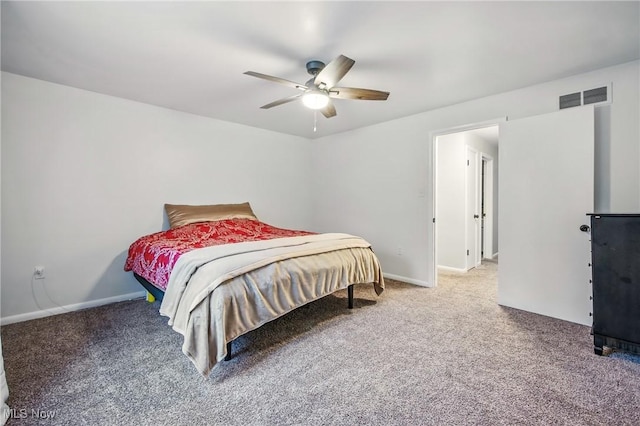 carpeted bedroom featuring visible vents, baseboards, and a ceiling fan