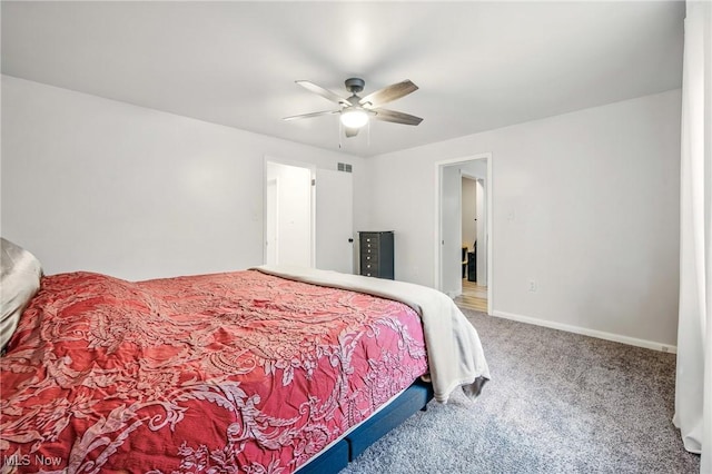 carpeted bedroom featuring visible vents, ceiling fan, and baseboards