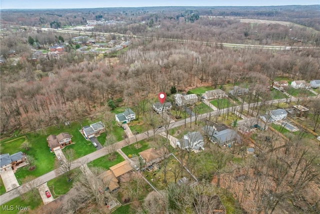 birds eye view of property featuring a wooded view