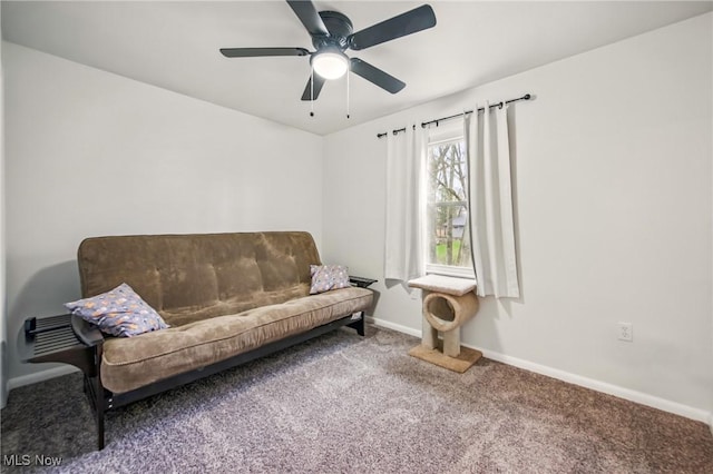 living area with carpet floors, baseboards, and ceiling fan