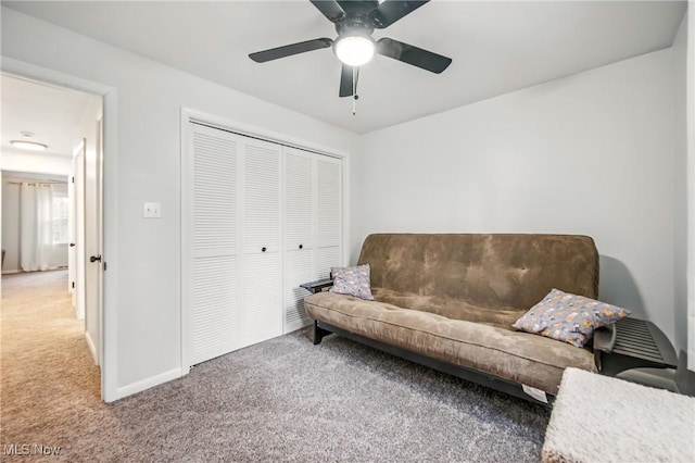 living area featuring carpet flooring, baseboards, and ceiling fan